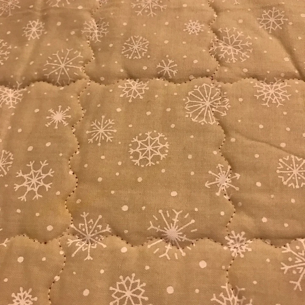 Handcrafted a quilted reversible table runner. Lots of stitching detail